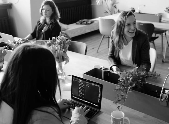 group of three office workers at computers